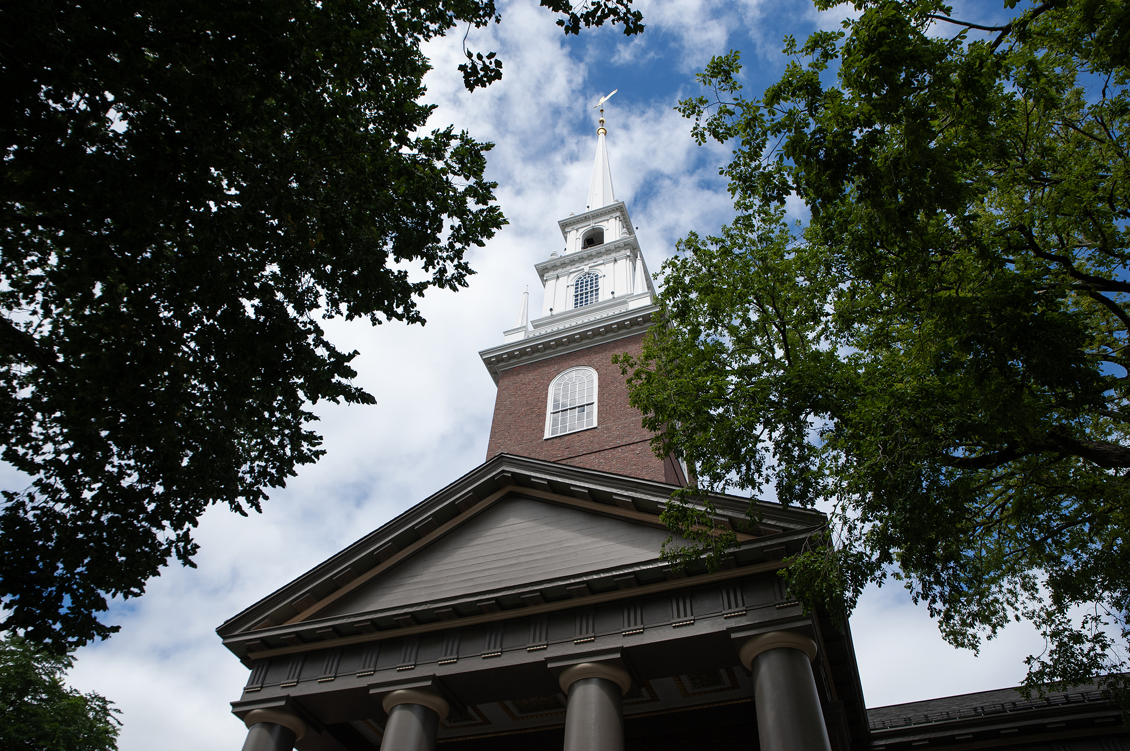 The Memorial Church of Harvard University under a blue summer sky