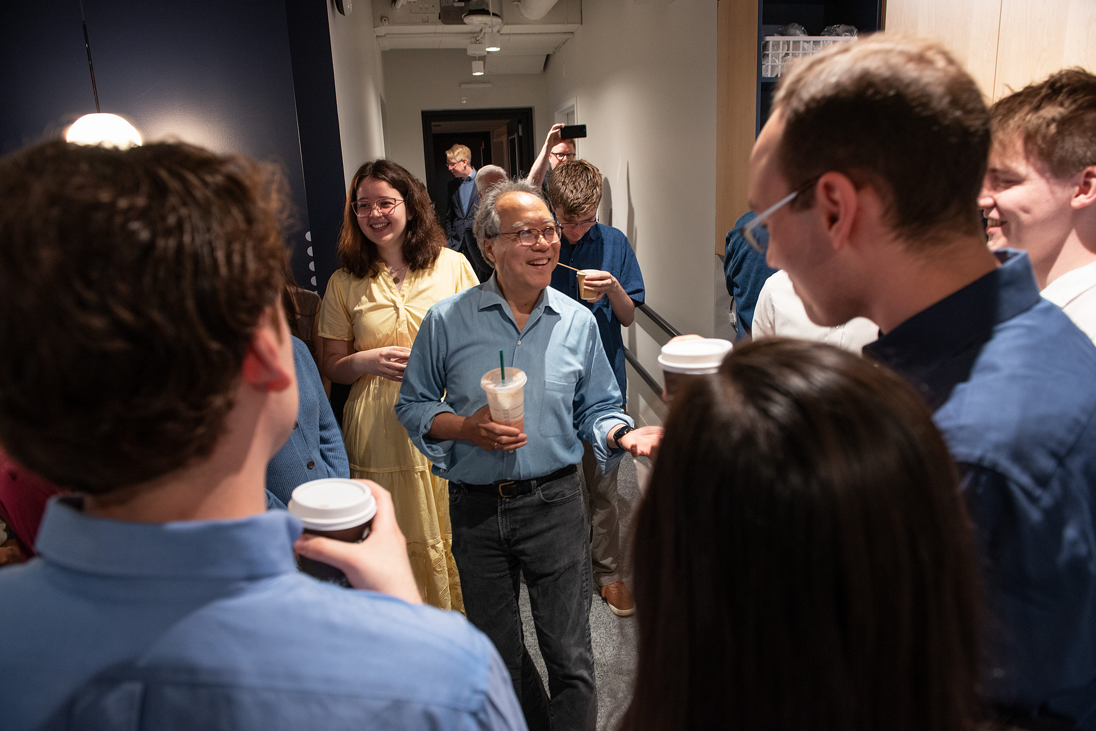 World-renowned cellist Yo-Yo Ma ’76 is greeted by members of the Harvard University Choir last May for a joint recording session. 