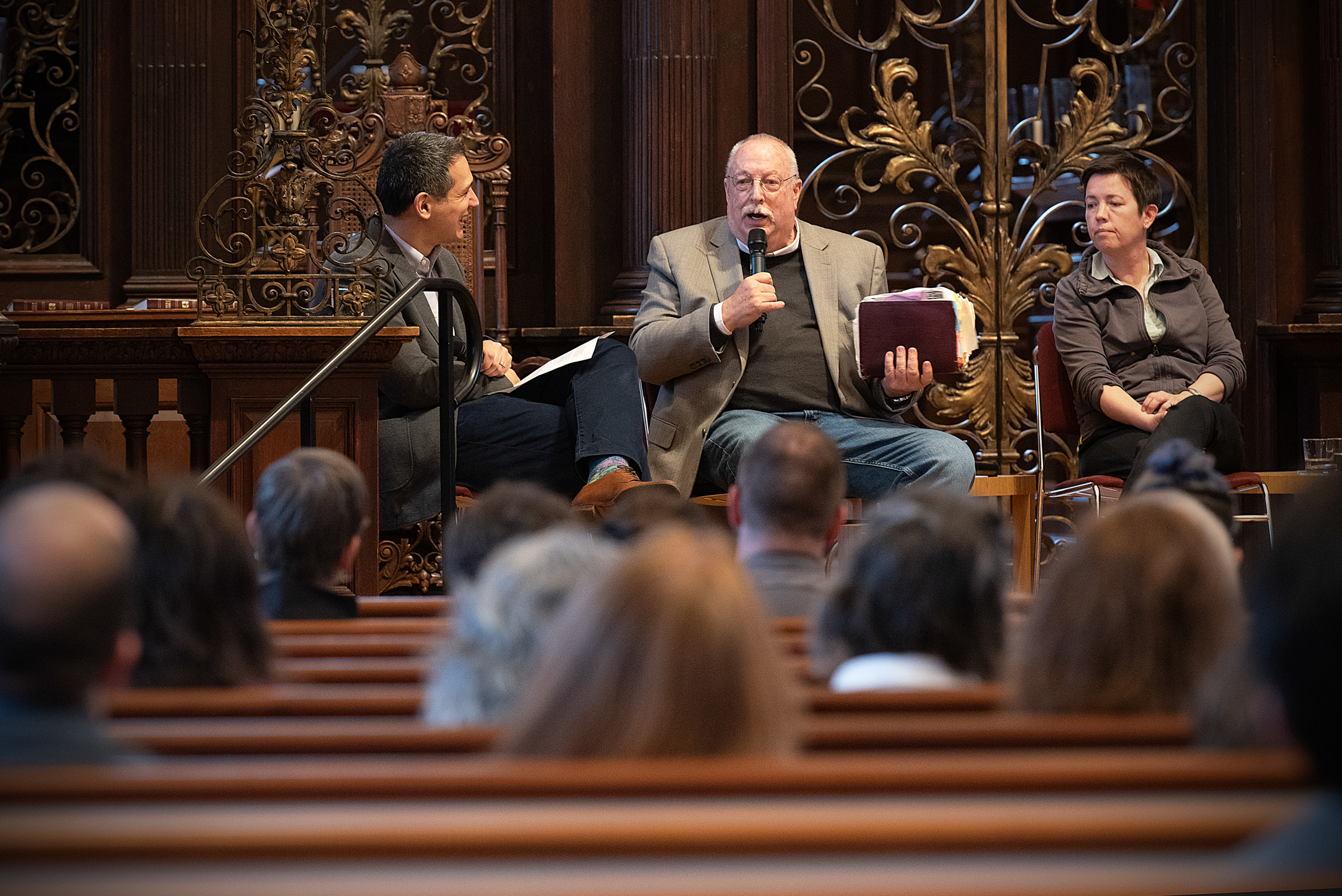 The Rev. Matthew Potts interviews The Rev. Jim Mitulski (second left), former pastor at the Metropolitan Community Church of San Francisco, in the Memorial Church Sanctuary.