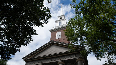 The Memorial Church of Harvard University under a blue summer sky