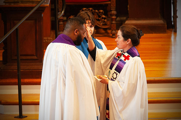 The Rev. Alanna Sullivan places ashes on the forehead of the Rev. Dr. Calvon Jones.