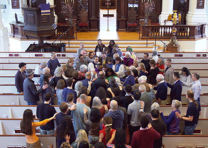 The Memorial Church congregation gathers around the Rev. Dr. Calvon Jones and his wife Alleya for a farewell blenning. 