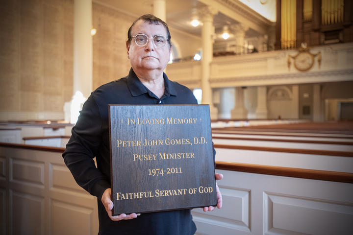 Carpenter Paul Indelicato holds panel dedicated to the Reverend Professor Gomes.
