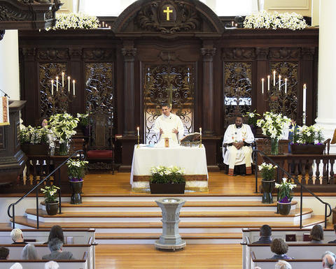 The Rev. Matthew Potts conducts communion on easter Sunday