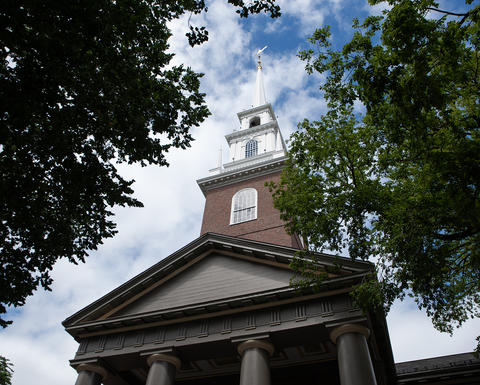 The Memorial Church of Harvard University under a blue summer sky
