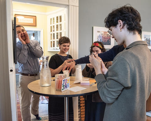 The Rev. Matthew Potts, asks for coffee orders from students attending After School Snack at Sparks House.