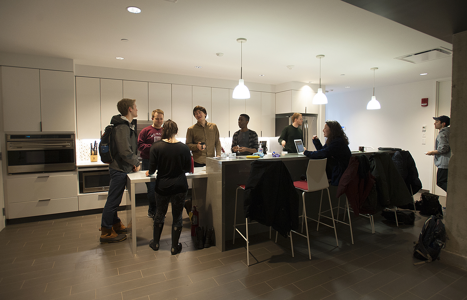 Members of the Harvard University Choir socialize in the new kitchen before rehearsal
