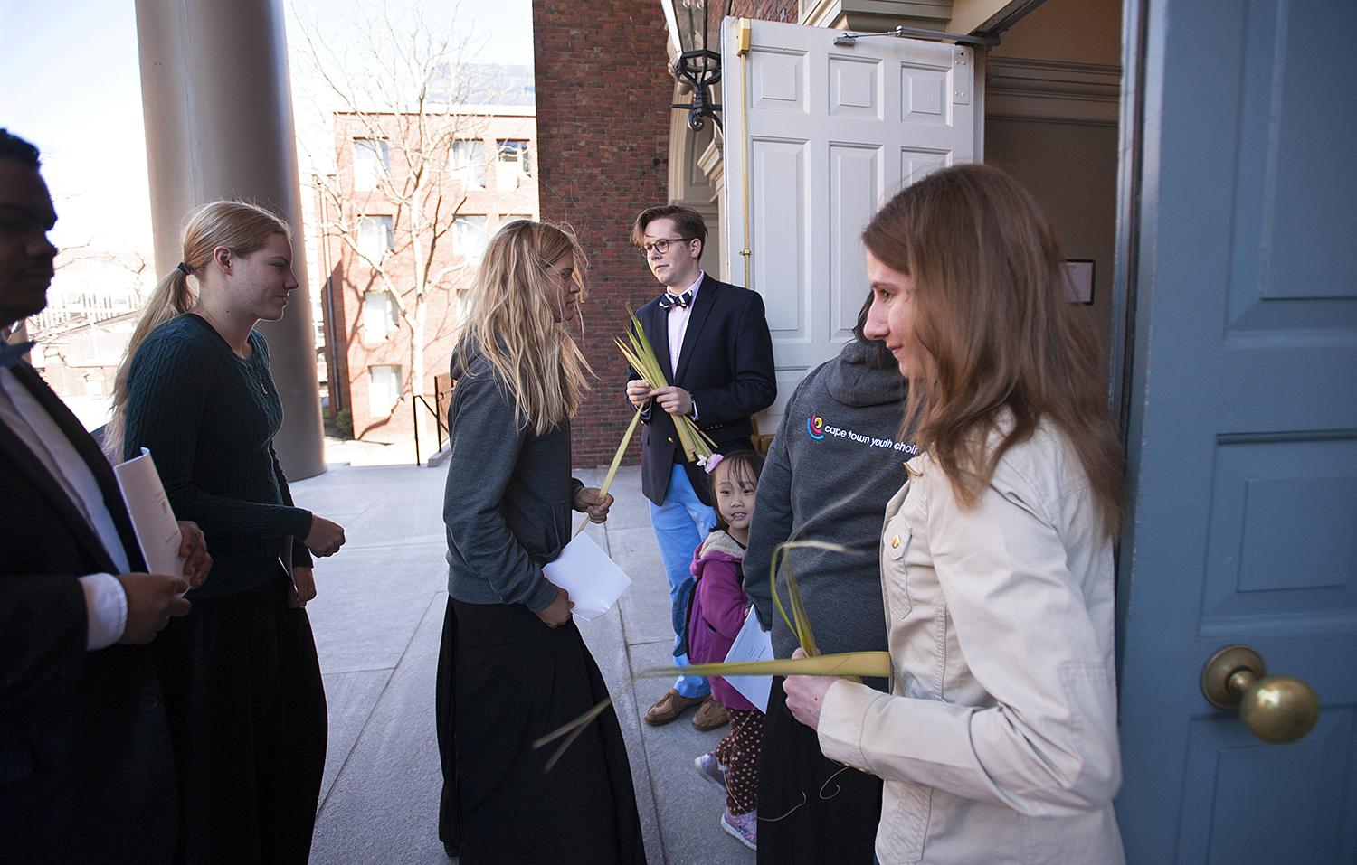 Student deacons hand out palms to the congregation on Palm Sunday