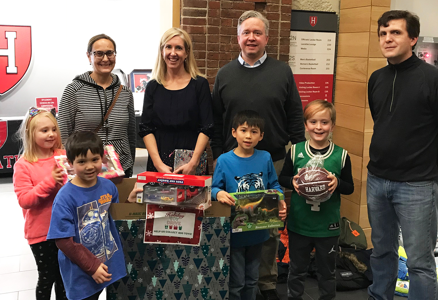 Members of the Church SChool collect toys at a Harvard Mens Baskball Game