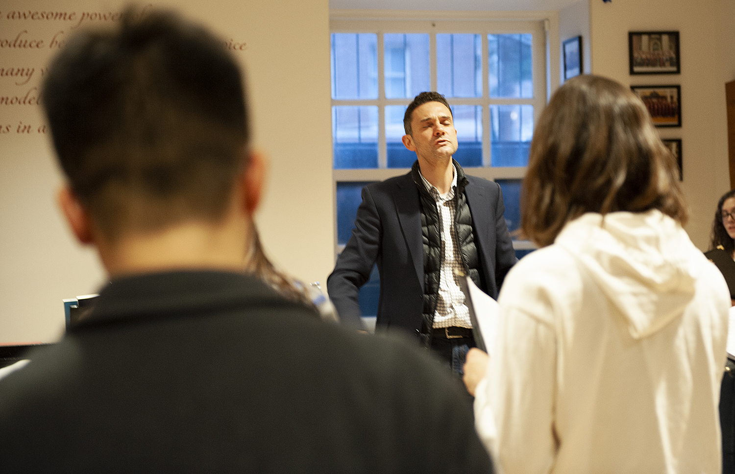 Choirmaster Edward Elwyn Jones works with choir members on music for the UK tour.