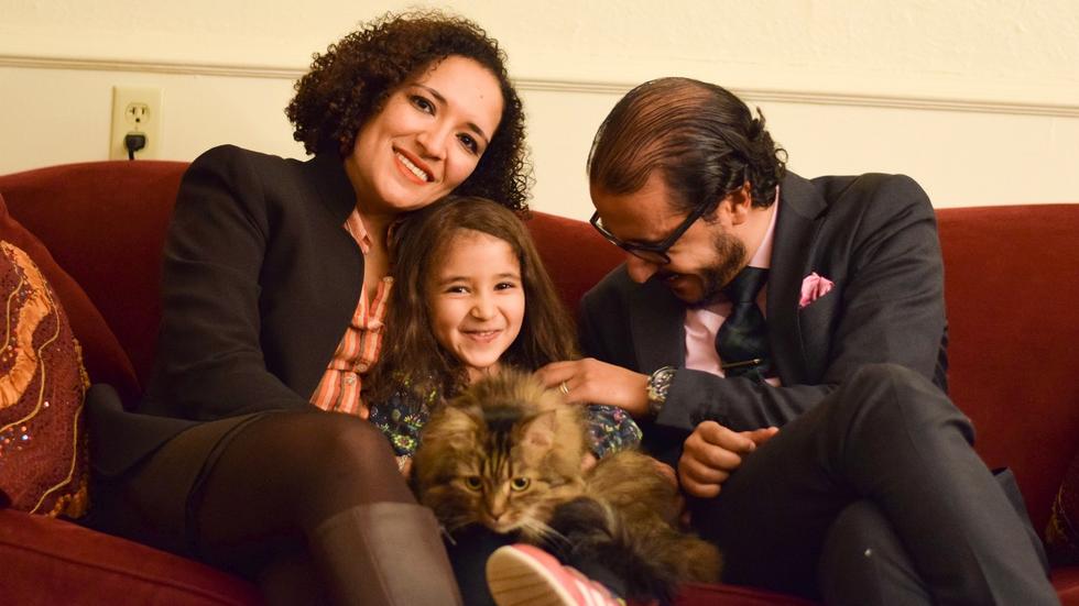 Professor Soha Bayoumi, their daughter Carmen holding their cat Jesse, and Professor Ahmed Ragab