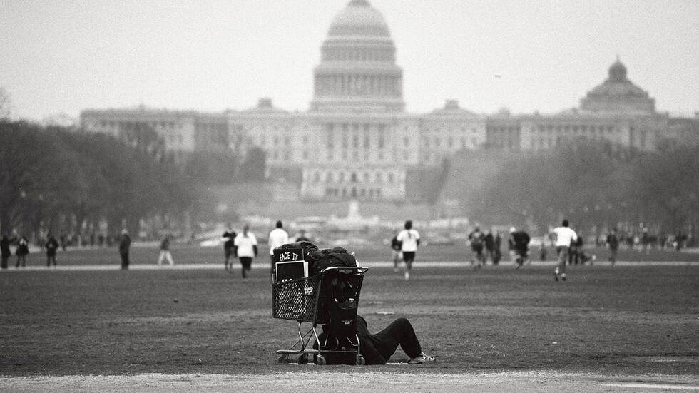 Homeless man in the shadow on the U.S. Capital